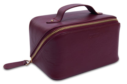 Maroon toiletry bag with gold zipper on a white background